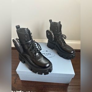 Prada 
Monolith brushed leather and nylon boots with 2 pouches.